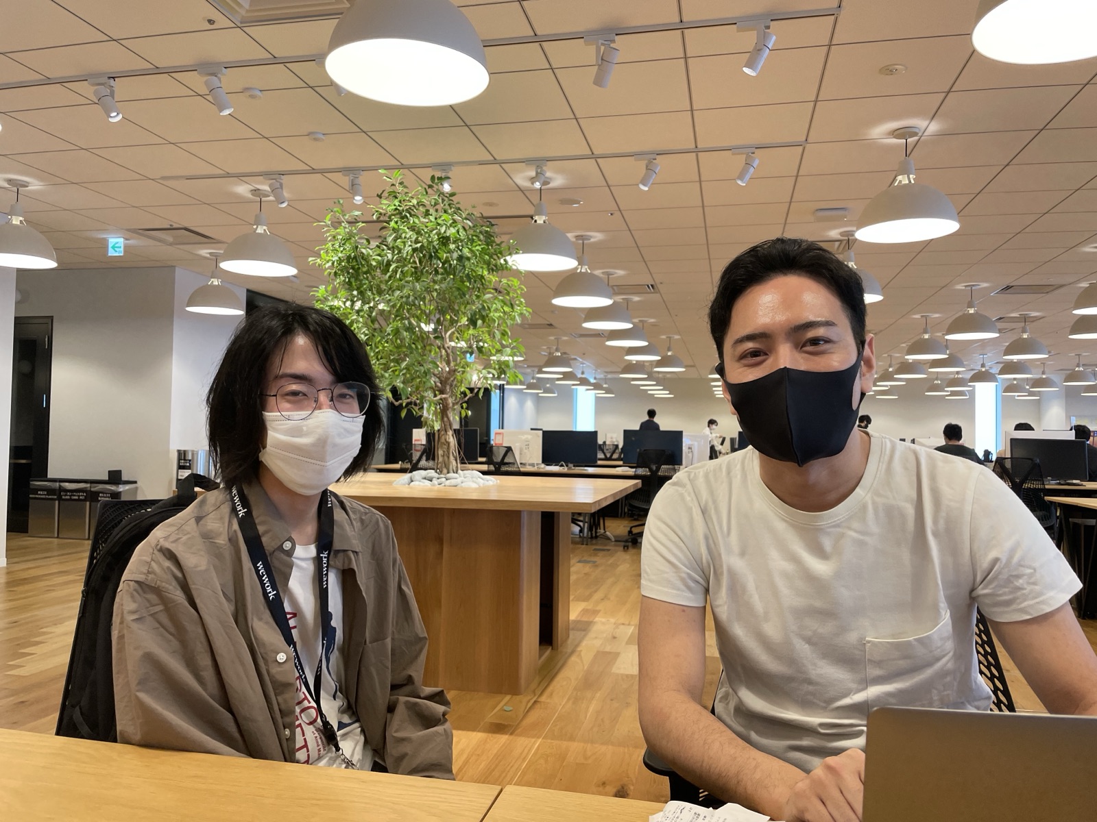 The two founders working side by side in a coworking space